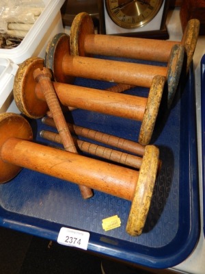 A group of wooden thread reels.