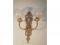 A brass neo classical design wall sconce with two acid etched globular shades