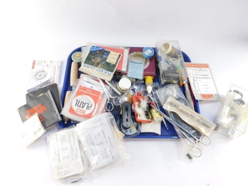 An assortment of trout fishing accessories, to include priest, forceps, line, etc. (1 tray)