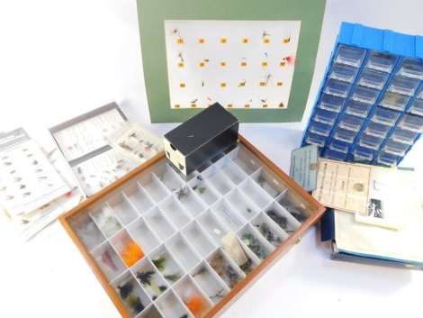 An assortment of fishing flies, to include retailers counter top display case with an assortment of flies, other selections and a retail dispenser with collection of various trout flies. (a quantity)