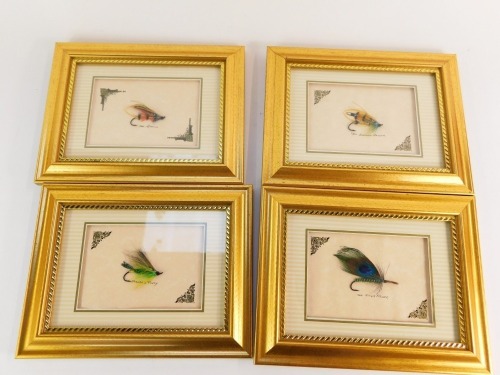 Four framed salmon flies.