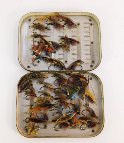 A collection of salmon fishing flies, contained in an antique metal case, lacking most of original black japanned finish.