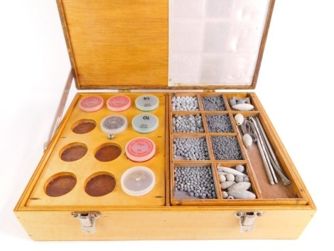 A wooden fishing tackle box, of two hinged compartments and including a collection of floats to upper tier, and predominantly weights to the lower section. Note - Please open with caution.