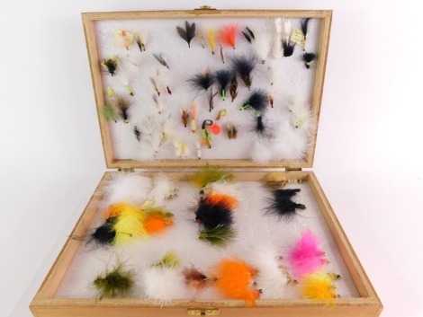 A wooden reservoir trout fly case, of two hinged sections and including a selection of reservoir flies, to include nymphs, lures, etc.