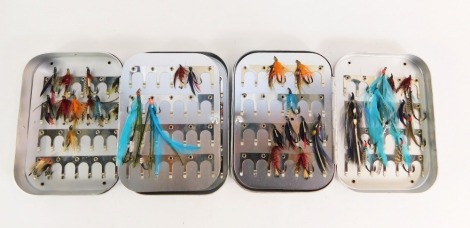 Two Wheatley Silmalloy metal fly cases, and a selection of sea trout and salmon flies.