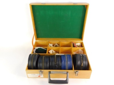 A wooden fitted travel case for fishing reels, and five Hardy plastic reel cases. (6)