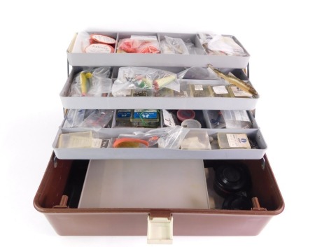 A plastic cantilever fishing tackle box, and tackle to include a collection of Devon Minnows, Toby lures, various other lures, weights, etc. (a quantity)