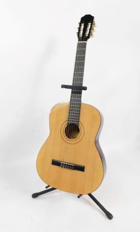 A Burswood acoustic guitar, with light beech finish, bearing label, with stand.