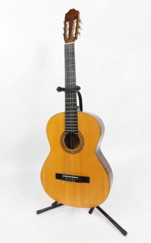 A Lenora acoustic guitar, in darkened wood finish with outer marquetry ring, bears label, on stand.