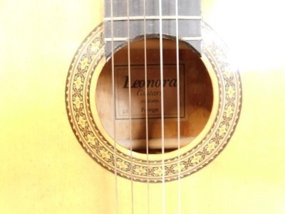 A Lenora acoustic guitar, in darkened wood finish with outer marquetry ring, bears label, on stand. - 2