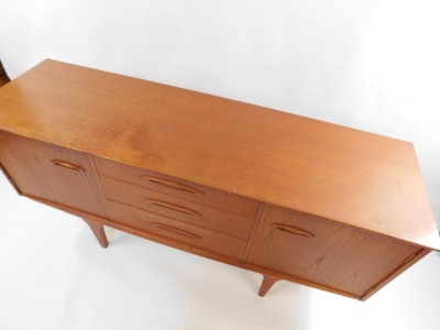 A mid century teak sideboard, with three central drawers, flanked by a pair of cupboard doors, raised on tapering square legs, 73cm high, 152cm wide, 44cm deep. - 3