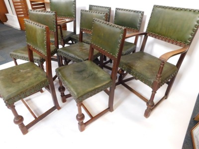 A set of eight Carolean revival oak dining chairs, with studded green leather backs and overstuffed seats, raised on turned legs, united by an H frame stretcher, comprising a pair of carvers and six single chairs. - 4