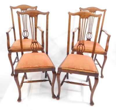 A set of four early 20thC Georgian style oak dining chairs, with drop-in seats, raised on cabriole legs, united by an H frame stretcher, comprising a pair of carvers and a pair of single chairs.