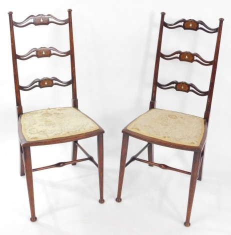 A pair of Victorian beech and inlaid ladder back bedroom chairs.