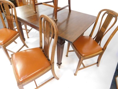 A Hepplewhite style mahogany dining suite, early 20thC, comprising a sideboard, with pair of doors, raised on channeled square legs on spade feet, 106cm high, 152cm wide, 53.5cm deep, together with a draw leaf dining table, with one additional leaf, 72cm - 4