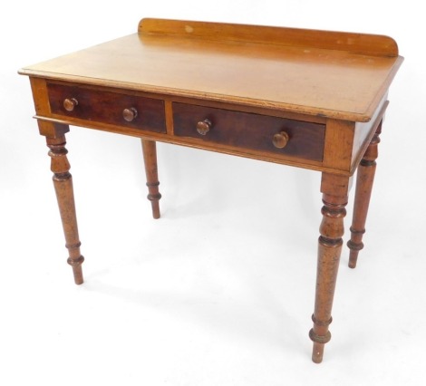 An early 19thC mahogany side table, with a pair of frieze drawers, raised on turned legs, 74cm high, 91cm wide, 54.5cm deep.