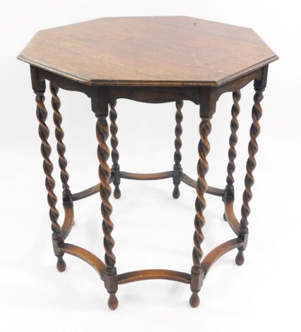 An early 20thC octagonal oak occasional table, raised on barley twist supports united by shaped stretchers, 65.5cm high, 61cm diameter.