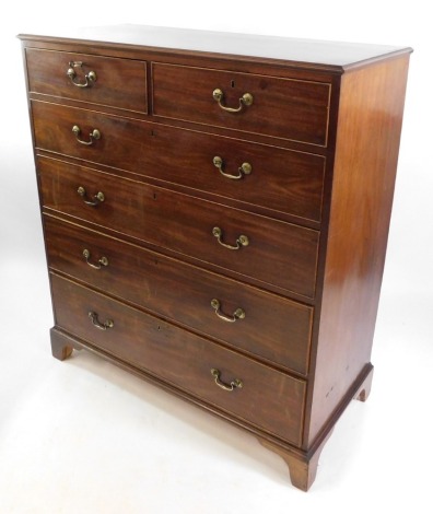 A George III mahogany chest, of two short over four long drawers, raised on cabriole legs, 131cm high, 117cm wide, 54cm deep.