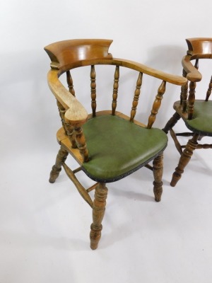 A pair of Victorian oak smoker's bow chairs, with later green button leatherette seats, raised on turned legs. - 3