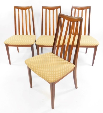 A set of four G-Plan teak 1960's single dining chairs, designed by Leslie Dandy, upholstered in floral gold patterned upholstery.