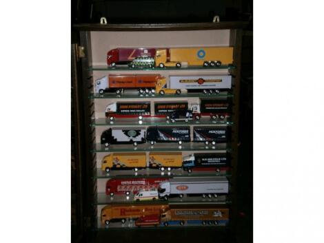 A cabinet with a collection of Corgi transport vehicles including:- Royal Mail