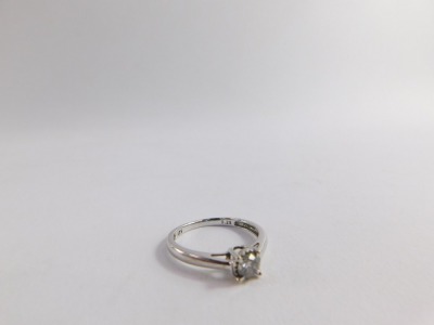 A diamond solitaire ring, with round brilliant cut diamond in four claw setting, 0.25cts, on splayed shoulders, ring size O½, 1.8g all in. - 4