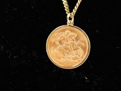 A George V full gold sovereign pendant and chain, dated 1912, on curb link chain marked 9ct, 60cm long, 22.1g all in. - 2