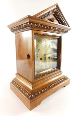 A Junghans late 19thC oak cased mantel clock, the brass dial with silvered chapter ring bearing Arabic numerals, eight day movement with coil strike, the case of architectural form with egg and dart moulding, raised on bracket feet, with key, 37.5cm high, - 3