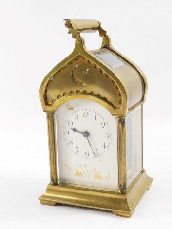 A late 19thC Duverdrey & Bloquel brass carriage timepiece, the white enamel dial painted in gilt with figures of swans and flowers, Arabic numerals, single barrel movement, the case of Islamic mosque form with crescent and star to the hood, impressed lion