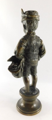 A Continental late 19thC bronze figure of an urchin boy, modelled standing holding a food sack, on a circular socle, unsigned, 37.5cm high. - 2