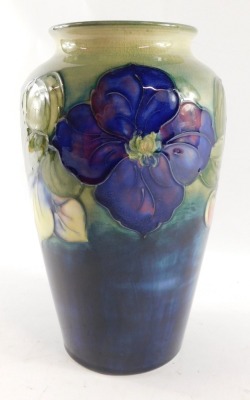 A Moorcroft pottery vase decorated in the Clematic pattern, against a green ground, painted and impressed marks, 21cm high. - 2