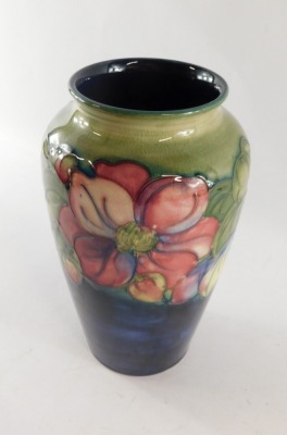 A Moorcroft pottery vase decorated in the Clematic pattern, against a green ground, painted and impressed marks, 21cm high. - 4