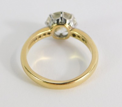 A diamond solitaire ring, with round brilliant cut diamond, measuring 8.4mm x 5.8mm, approx 2.5 carats overall, in a eight claw raised basket, platinum setting, with four tiny diamonds set shoulders, on yellow gold band, marked 18ct, size P, 5g all in. - 2