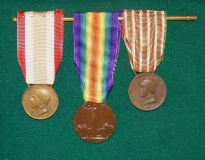 A collection of medal groups and records relating to the Pusterla family, including family trees, birth and marriage certificates, photographs and printed ephemera. The framed and glazed medal groups comprise a WWI Italian set of three, the Inter-Allied V - 2