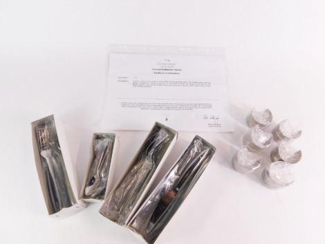 A Concorde British Airways six place setting stainless steel cutlery set, designed by Terence Conran, comprising knife, fork, dessert and tea spoons, together with six Sola stainless steel napkin rings, with certificate of authenticity from Concorde's Ent