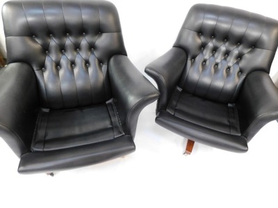 A pair of G-Plan mid century black vinyl swivel chairs, each on a wooden base with castors, with button back and detailing, 85cm high, 92cm wide, 85cm deep. - 4