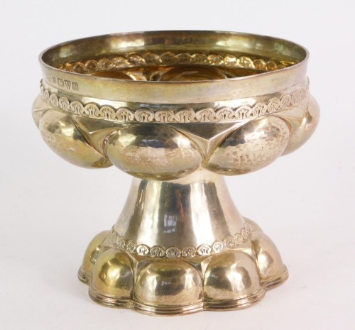 An Edward VII silver pedestal sweetmeat dish, with arch pleated top and flared lobed body, with hammered finish, George Nathan & Ridley Hayes, Chester 1908, 12cm high, 14¼oz.