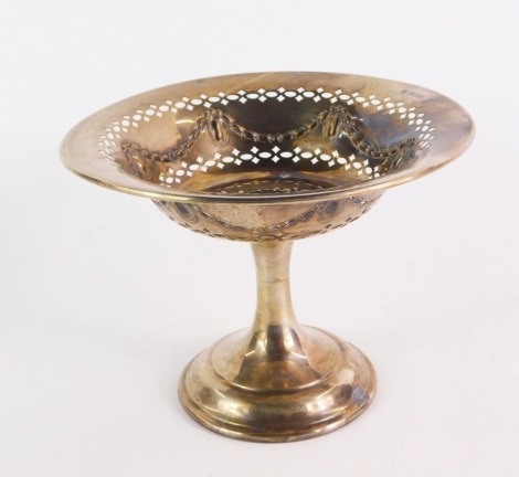 A George V loaded silver tazza, the dish with pierced and embossed swag decoration, raised on a waisted stem, Sheffield 1912, 72oz gross with loaded base.