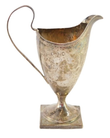 A George III Neo Classical silver helmet shaped cream jug, engraved with floral and foliate swags, shield reserve monogram engraved, possibly John Mewburn London 1786, 3¼oz.