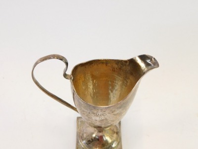 A George III Neo Classical silver helmet shaped cream jug, engraved with floral and foliate swags, shield reserve monogram engraved, possibly John Mewburn London 1786, 3¼oz. - 2