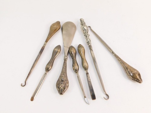 A group of silver handled manicure tools, comprising shoe horns, button hooks and manicure implements, 6½oz gross. (a quantity)