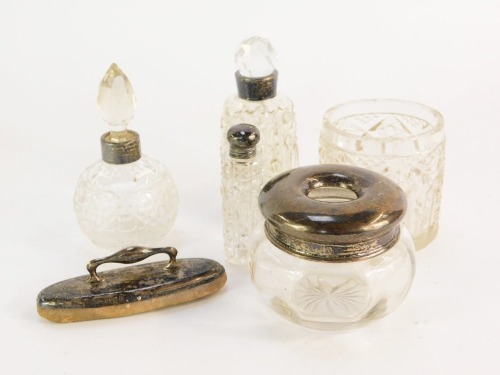 A group of dressing table jars, each with silver collar, together with a silver topped nail buffer. (a quantity)