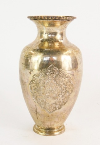 An Eastern vase of baluster form, repousse decorated with four reserves of flowers, white metal, 17cm high, 9½oz.