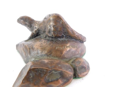 M W Pierce. A bronzed figure of an otter, modelled on a river bank, 8cm wide, on cushioned base. - 2