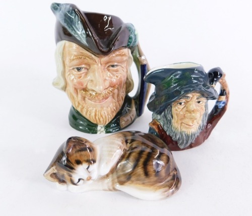 A group of Royal Doulton, comprising The Robin Hood D6534 character jug, 9cm high, Rip Van Winkle D6517, 6cm high, and a seated cat, 8cm wide (AF). (3)