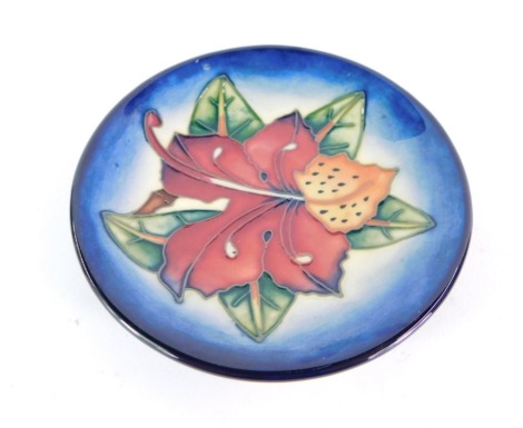 A Moorcroft pottery pin dish decorated in the Simeon pattern, dated 99, painted and impressed marks, 12cm diameter.