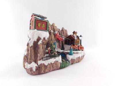 A Christmas musical figure group, on a plastic moulded base, with train and cart figures, 22cm high, 30cm wide. - 2