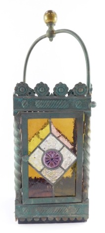 A Victorian style stained glass lantern, the metal finished outer surround with root supports, the rectangular glazed panel with yellow and pink finished glaze, 44cm high, 16cm wide.