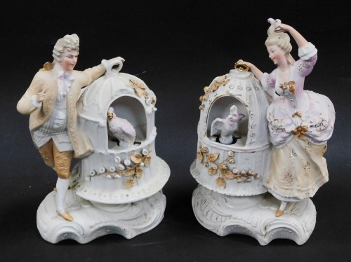 A pair of continental late 19thC bisque porcelain figures, of a gallant and lady, each modelled standing aside a birdcage holding a cockatiel and parrot respectively, raised on a rococo scroll base, impressed marks, 23cm high.