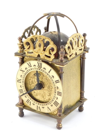 A Smiths Industries brass lantern clock, engraved dial with chapter ring bearing Roman numerals, quartz movement, the case of conventional form with strike bell, 15cm high.